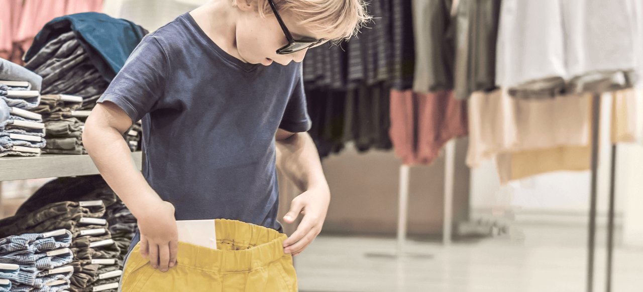 Child trying new dresses in Retail store