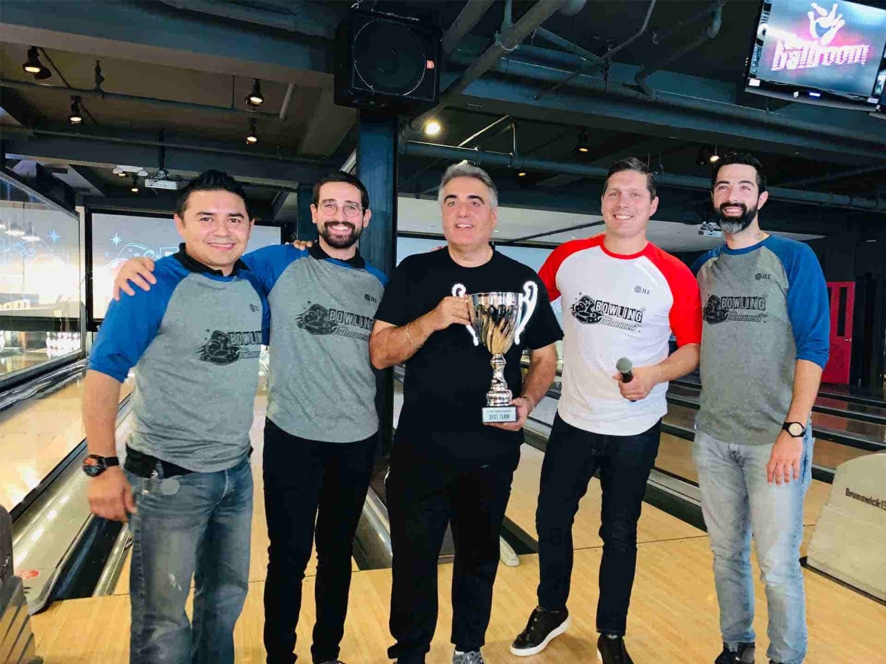 Winning champions with trophy in bowling game
