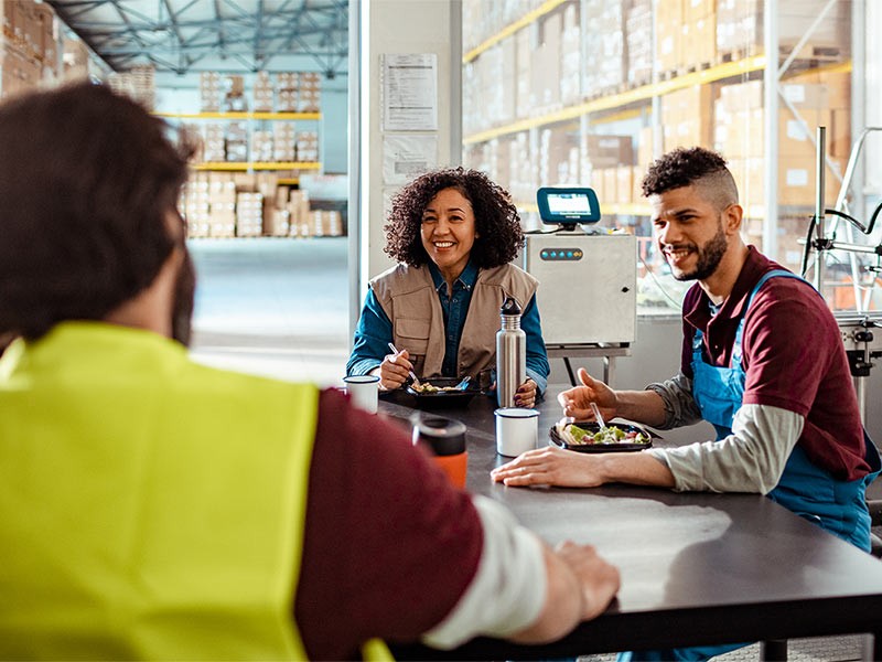 Workers on lunch break in a warehouse