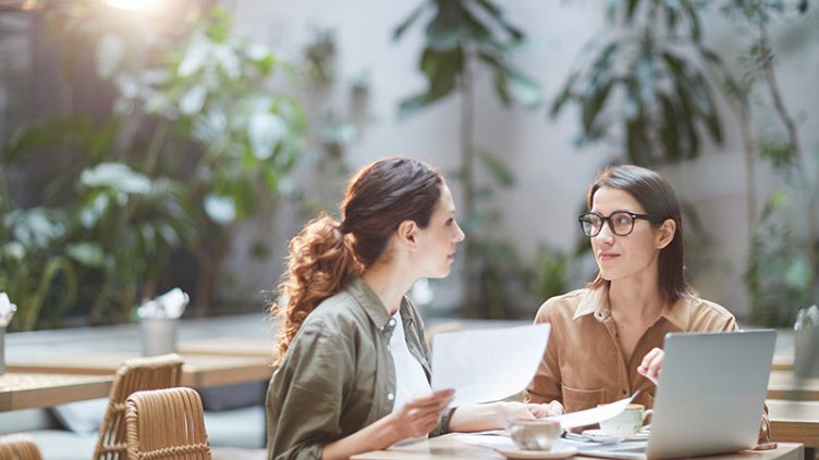 Two Young Businesswomen in Cafe
