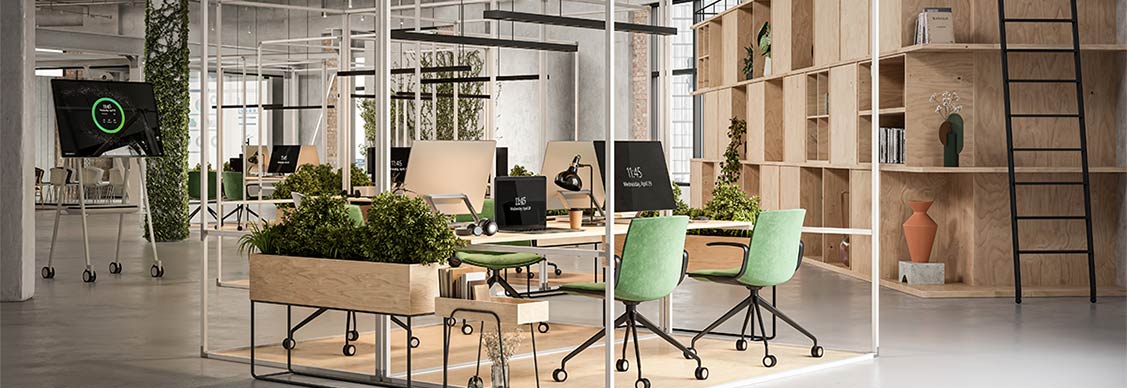 An office space featuring green plants and comfortable chairs arranged for a welcoming atmosphere.