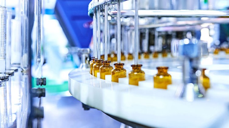 Brown medicine glass bottles on production line.