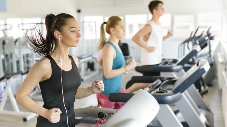 People working out on treadmill inside a gym