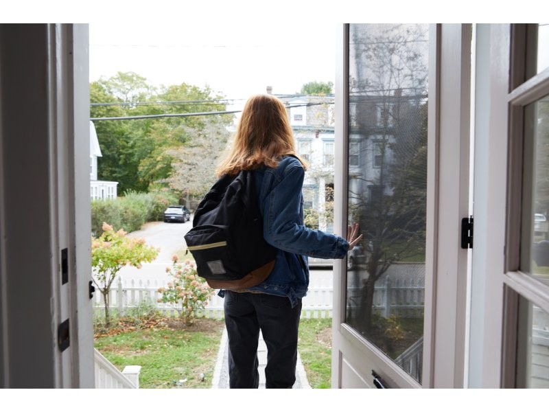 A girl standing near the door