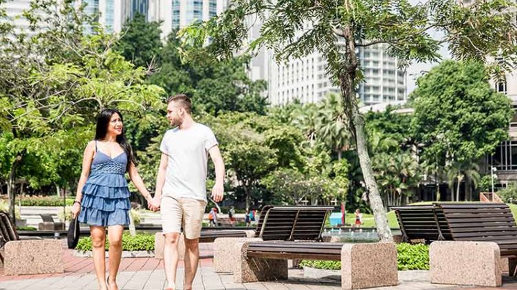 A couple is walking holding hands