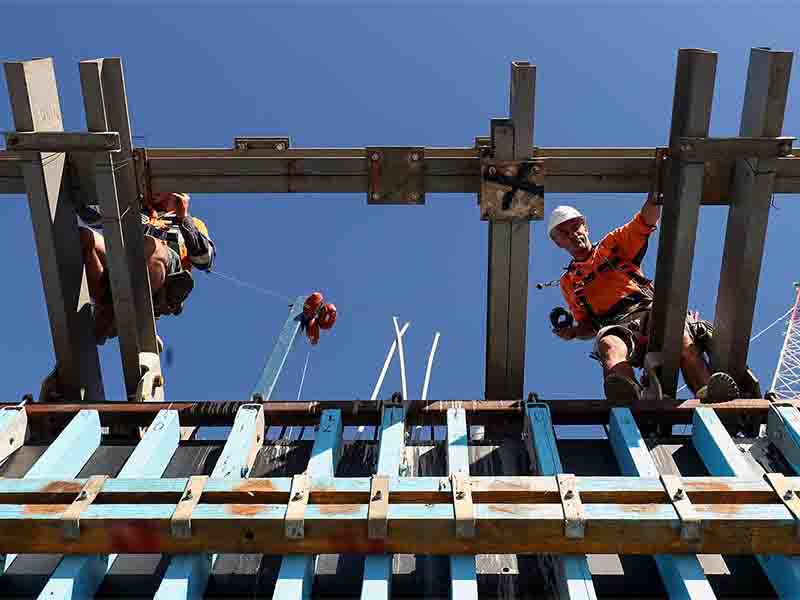 Male workers doing construction in commercial building project