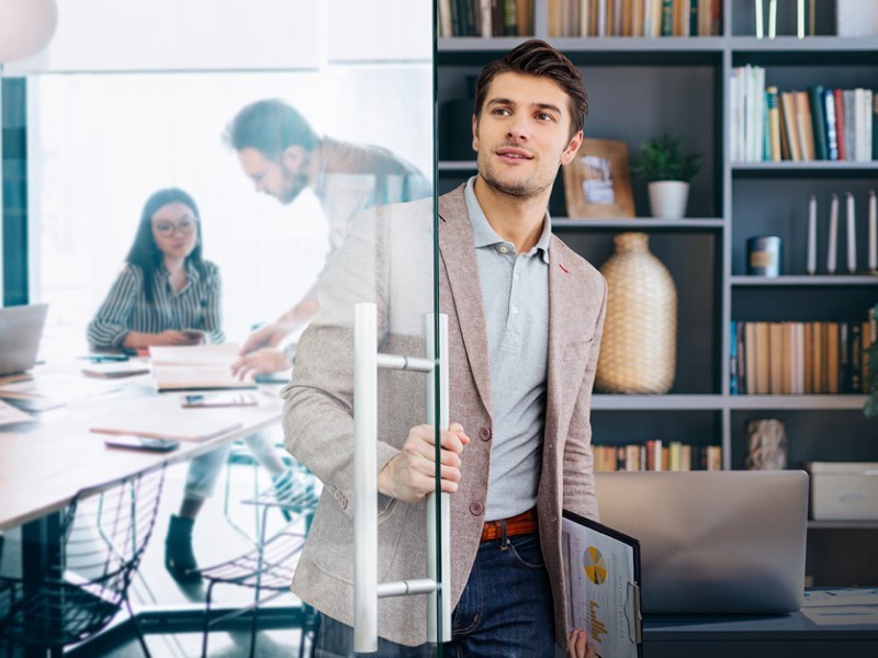 Man going inside the meeting room in JLL office building