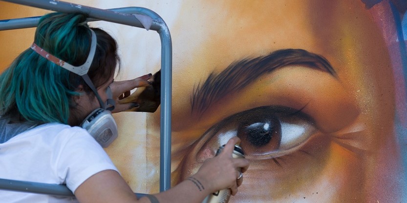 An artist paints a commissioned mural